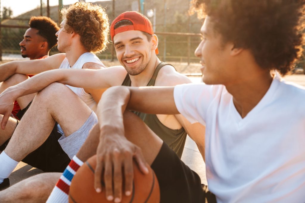 Men smiling on a basket court