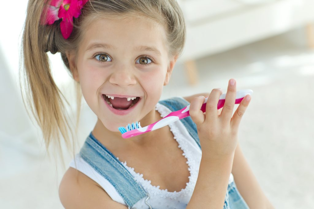 small girl with toothbrush
